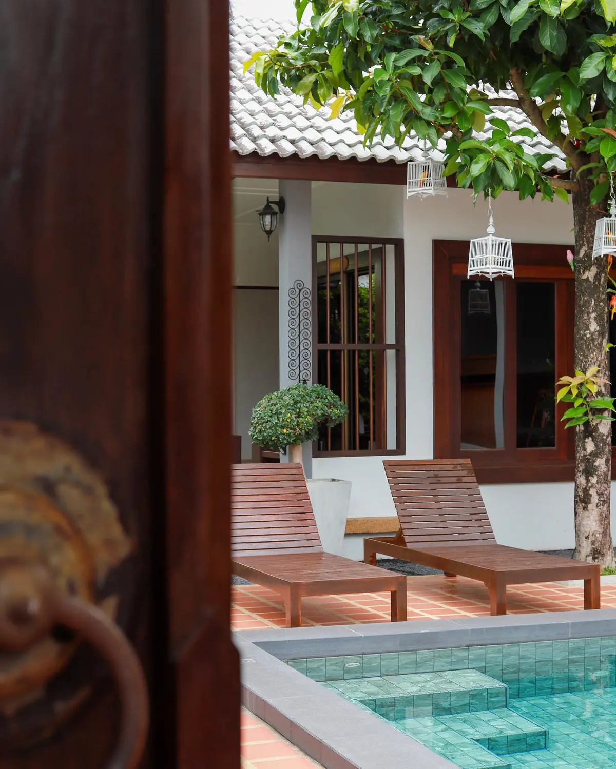 Poolside loungers through doorway